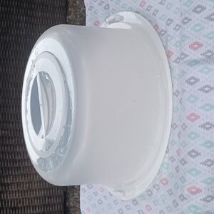 11 1/2" round cake holder by about 7" tall. Plastic, securing bottom to top used